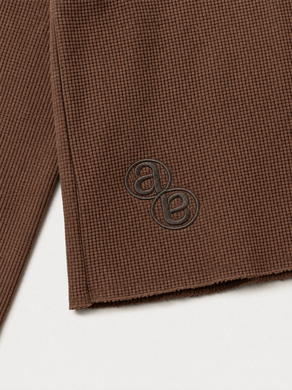 Box Henley Cedar — tonal AB monogram embroidery at the lower back