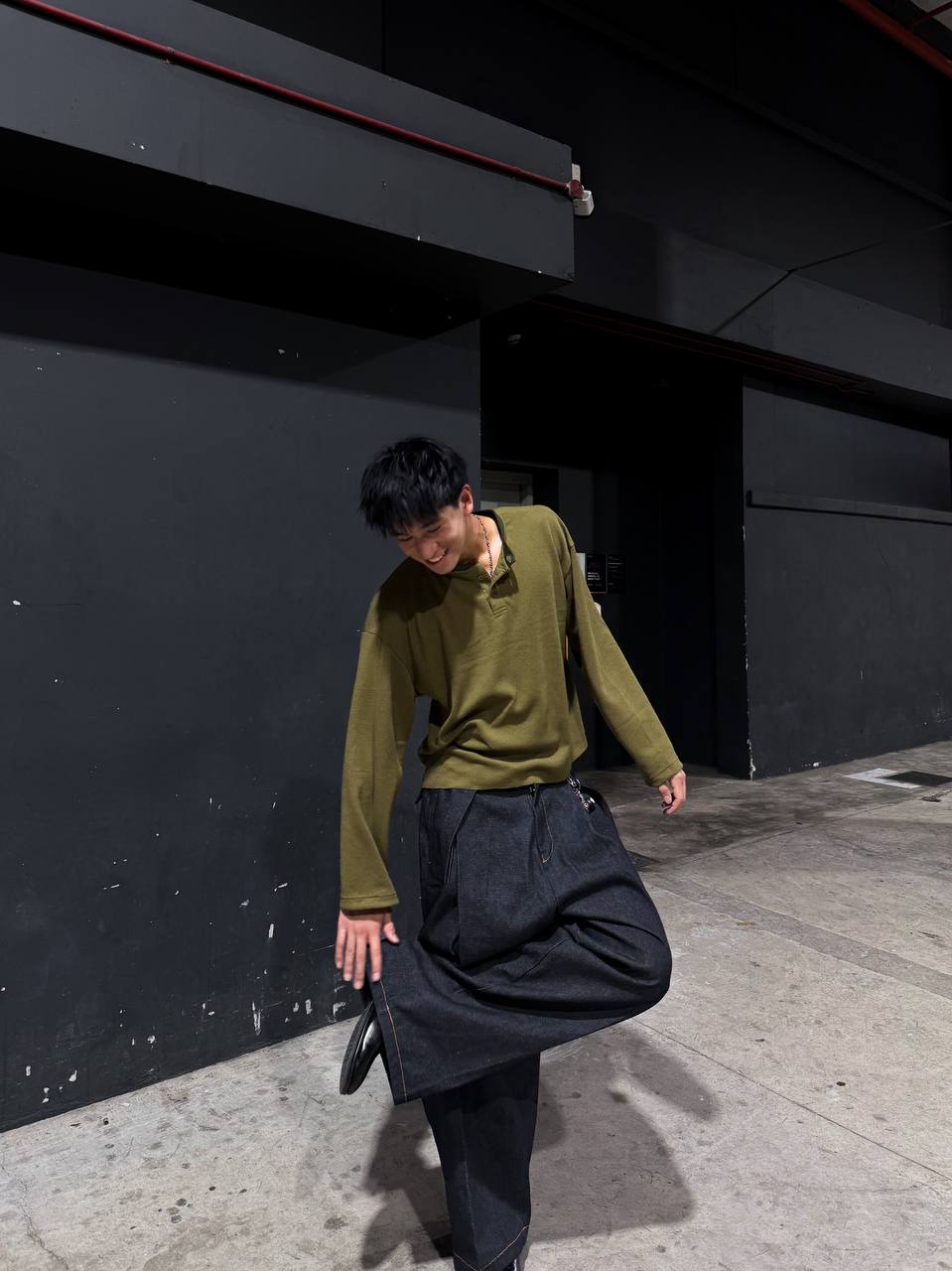 Box Henley Moss worn on model — full length street shot