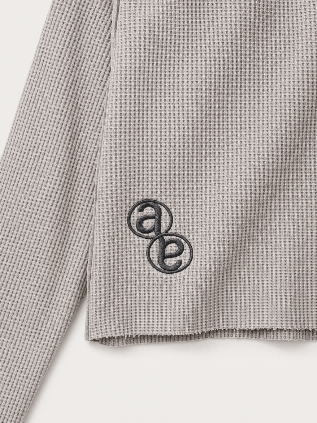 Box Henley Stone — tonal AB monogram embroidery at the lower back