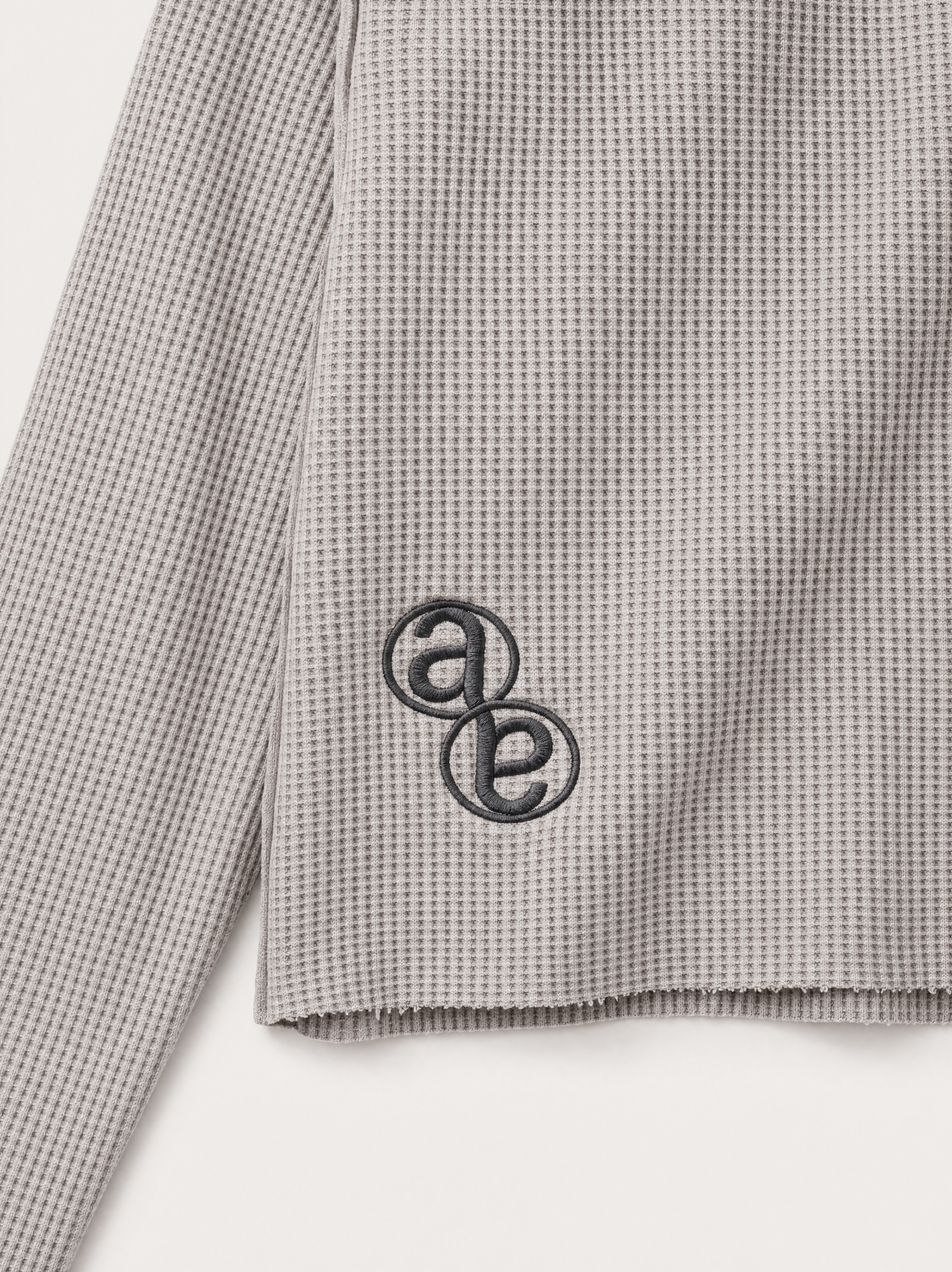 Box Henley Stone — tonal AB monogram embroidery at the lower back