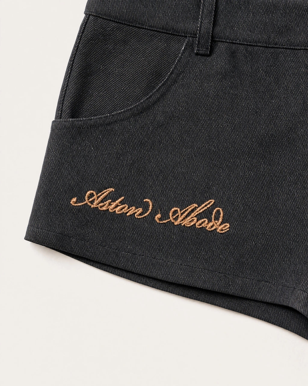 Sidebar Microshorts gold Aston Abode script embroidery detail