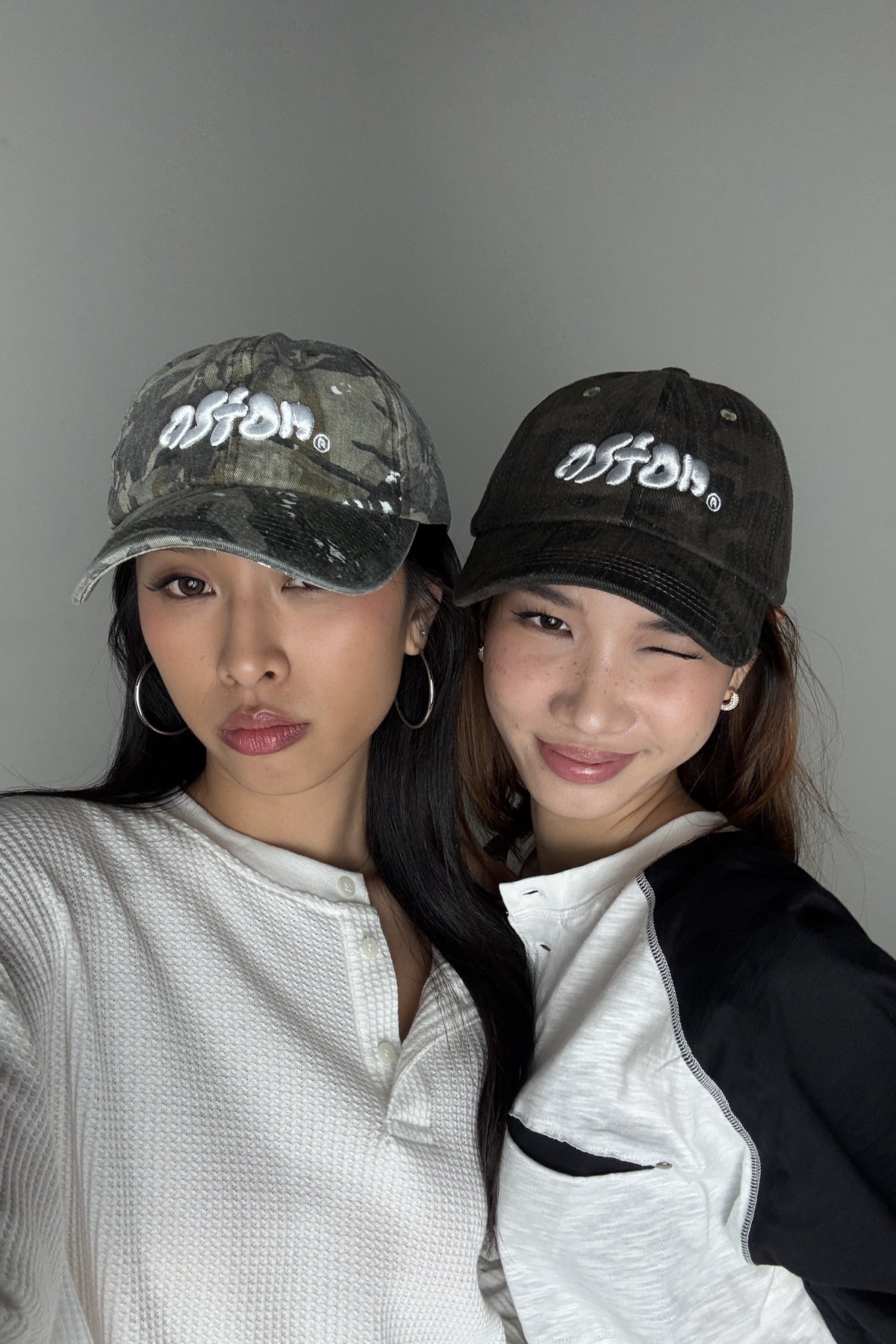 Aston Abode Staple Cap in Real Tree, lifestyle shot on Hera and Clarice