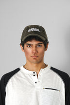 Aston Abode Staple Cap in Terrain, lifestyle shot on Aarav