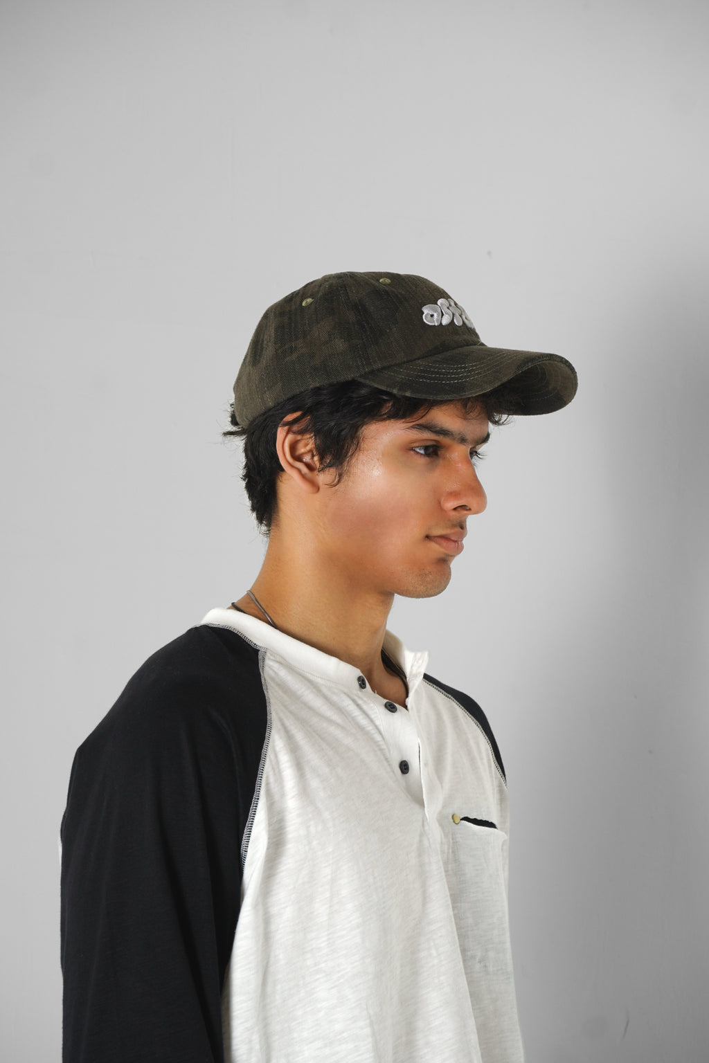 Aston Abode Staple Cap in Terrain, lifestyle shot on Aarav