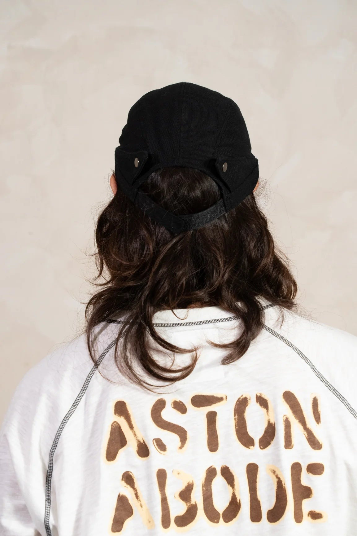 Aston Abode Banana Cap in Charcoal, back view, worn