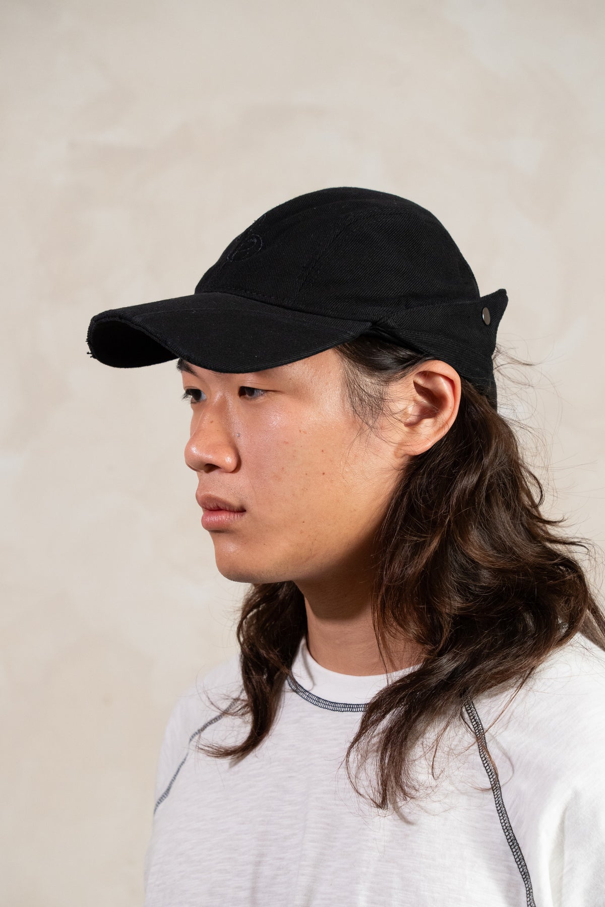 Aston Abode Banana Cap in Charcoal, quarter view, worn