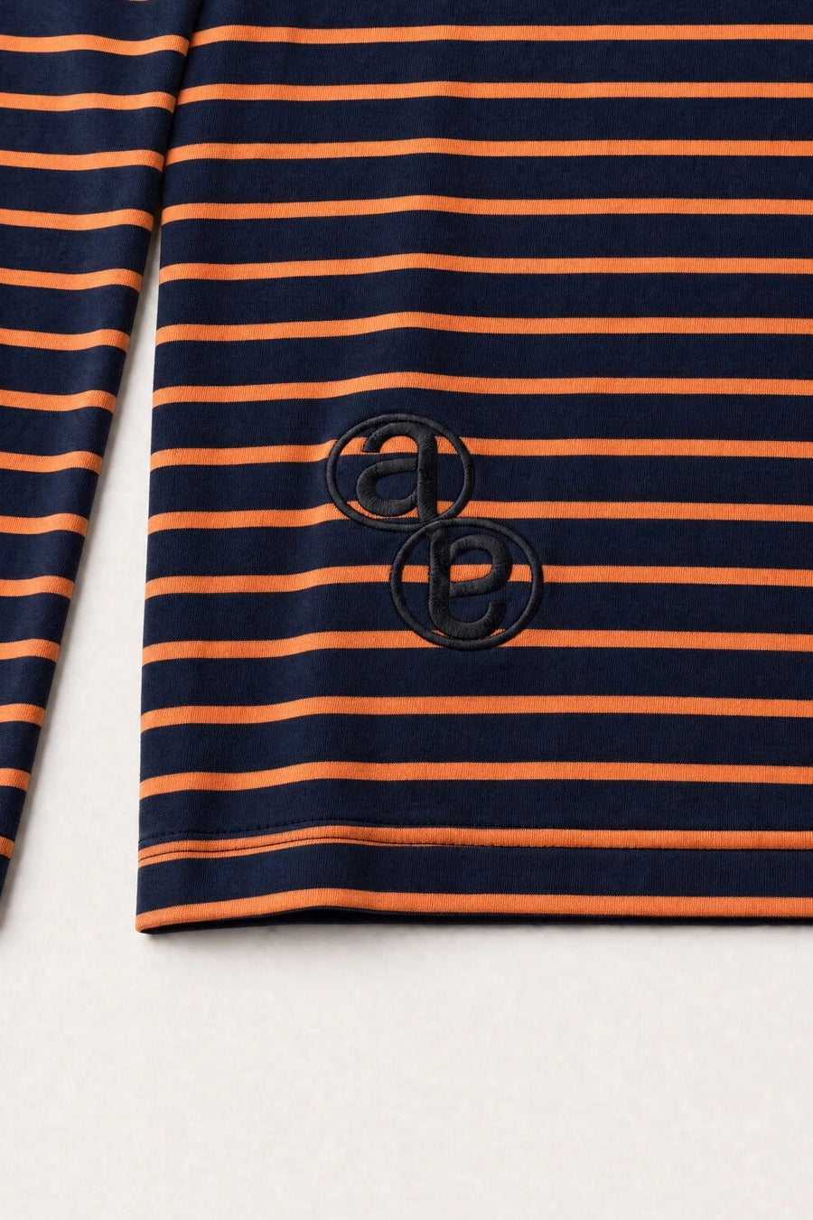 Aston Abode Box Henley in Negroni, monogram detail close-up